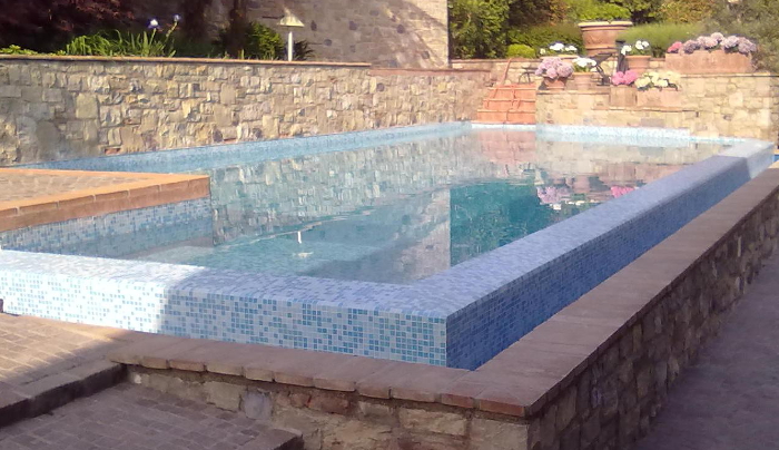 piscina a sfioro a cascata in mosaico